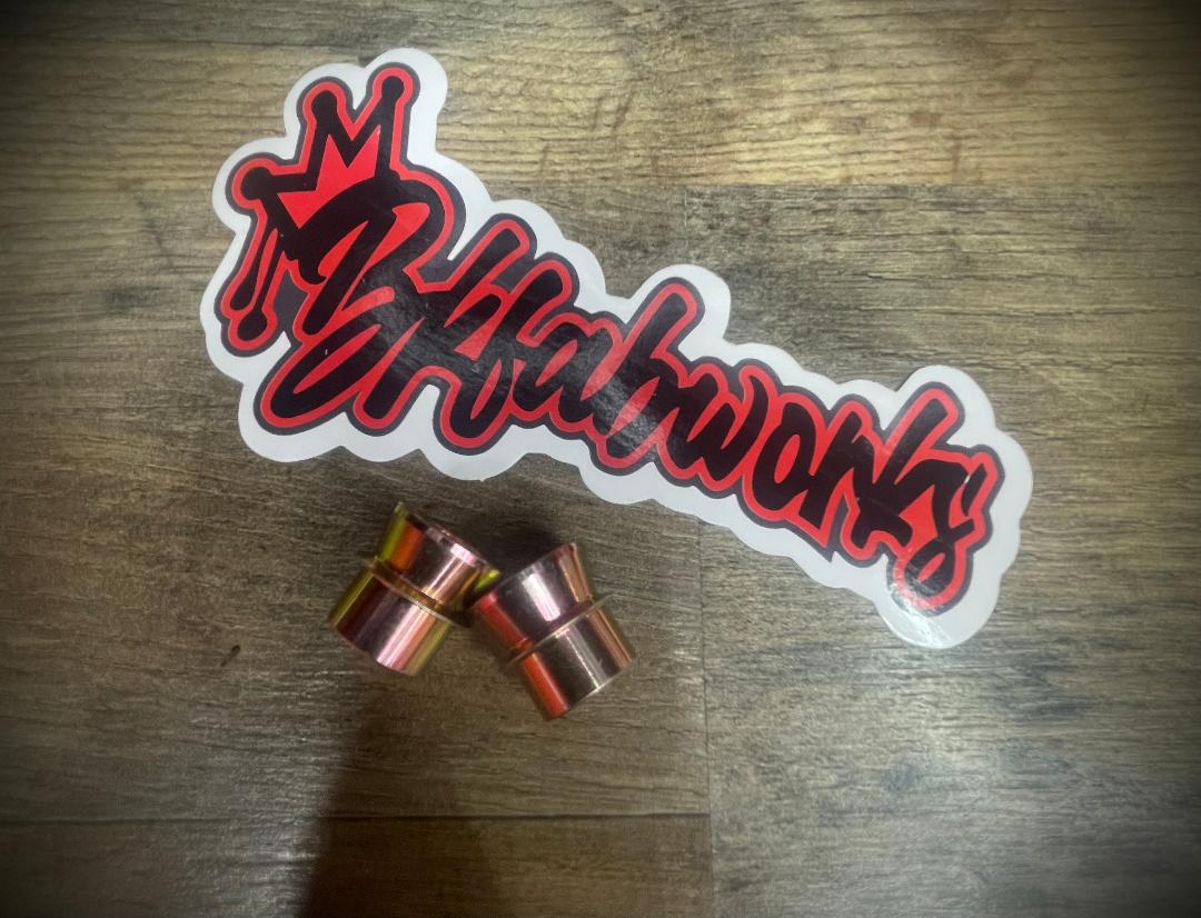 Set of zinc-coated 5/8 inch to 1/2 inch high misalignment spacers with BKFabworks logo sticker on wood background.