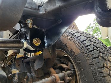 Installed view of BKFabworks 94–02 Dodge Ram heavy-duty weld-on track bar bracket with heim joint setup