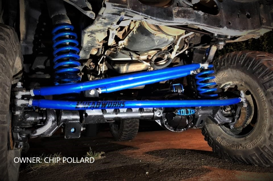 BKFabworks blue powder-coated 3-link steering and track bar setup installed on off-road Jeep XJ, custom build by Chip Pollard
