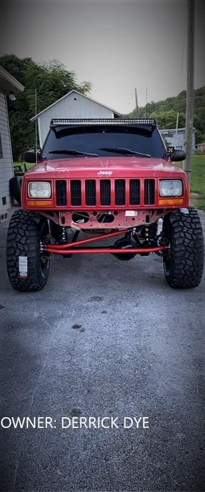 Red Jeep XJ equipped with BKFabworks high-clearance steering kit, full front suspension upgrade, build by Derrick Dye