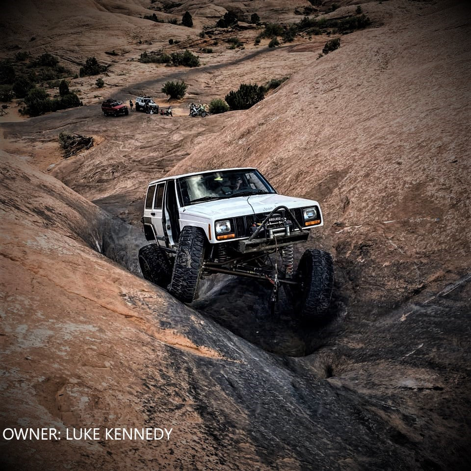 Luke Kennedy's Jeep Cherokee XJ equipped with BKFabworks steering and suspension components, rock crawling in Moab-style terrain.