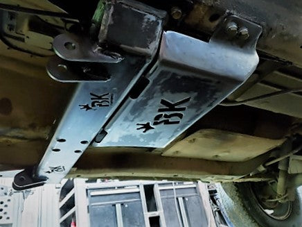 Installed BKFabworks standard skid plate and crossmember assembly on Jeep or Dodge 4x4. Bolt-on protection with laser-cut BK logo