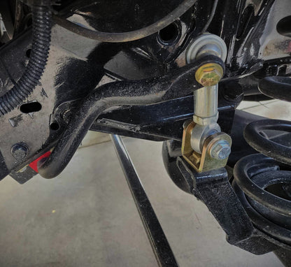 Front view of BKFabworks sway bar end link installed on 1994–2002 Dodge Ram 2500 4x4, showing heim joint connection to sway bar and control arm
