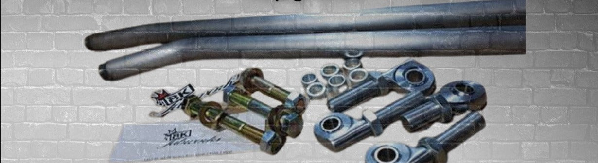 BKFabworks heavy-duty 2nd Gen Dodge Ram steering kit with heim joints, hardware, and steel tie rods on brick background display

