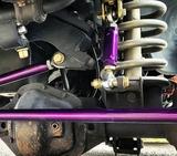 Close-up of Dodge Ram suspension with purple heavy-duty sway bar end link kit installed from BKFabworks